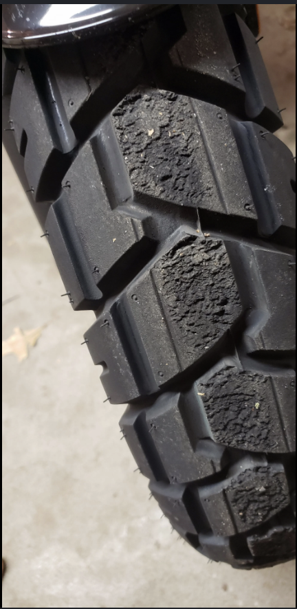 Close-up tire tread showing contact wear pattern from rubbing
